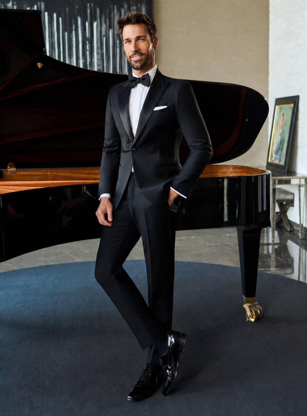 Deep navy Consiglieri tuxedo with lustrous lapels, a white shirt and black bow tie