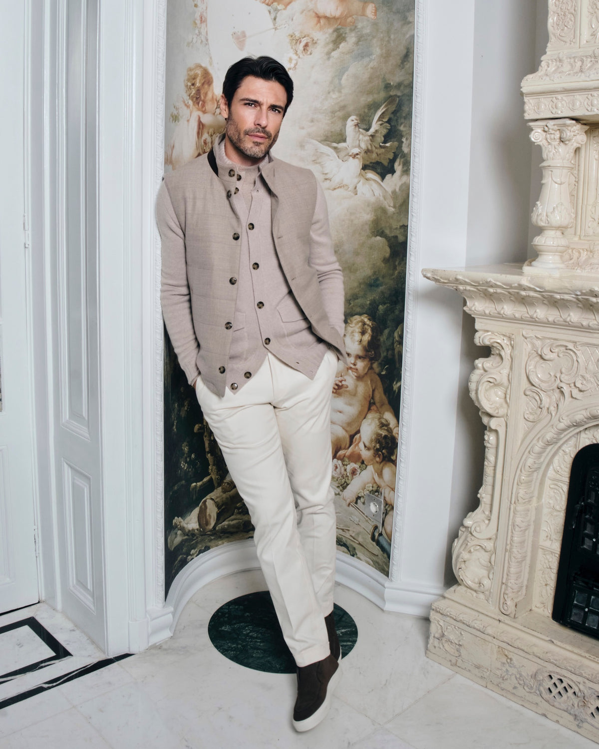 Taupe Consiglieri cardigan with buttons and a stand collar, worn with white trousers