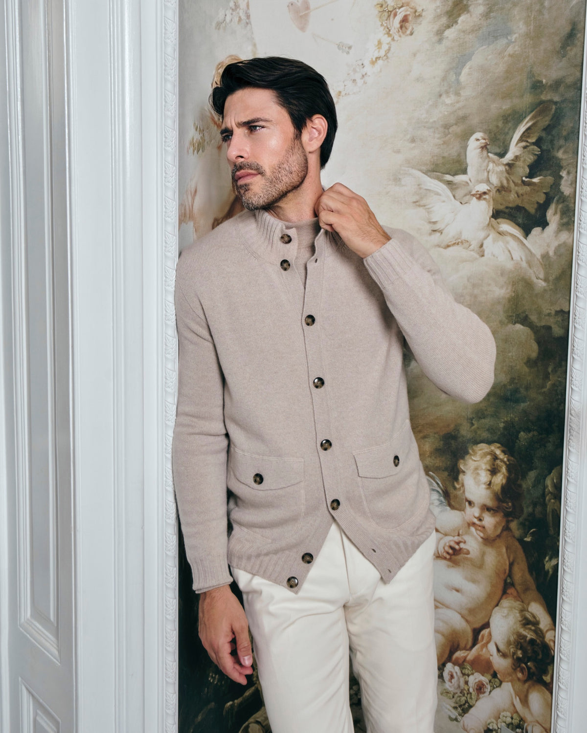 Taupe Consiglieri cardigan with buttons and a stand collar, worn with white trousers