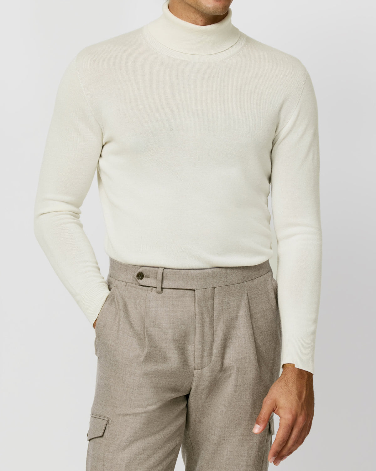 Off-white Consiglieri turtleneck worn with beige cargo-pocket trousers