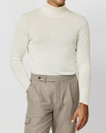 Off-white Consiglieri turtleneck worn with beige cargo-pocket trousers