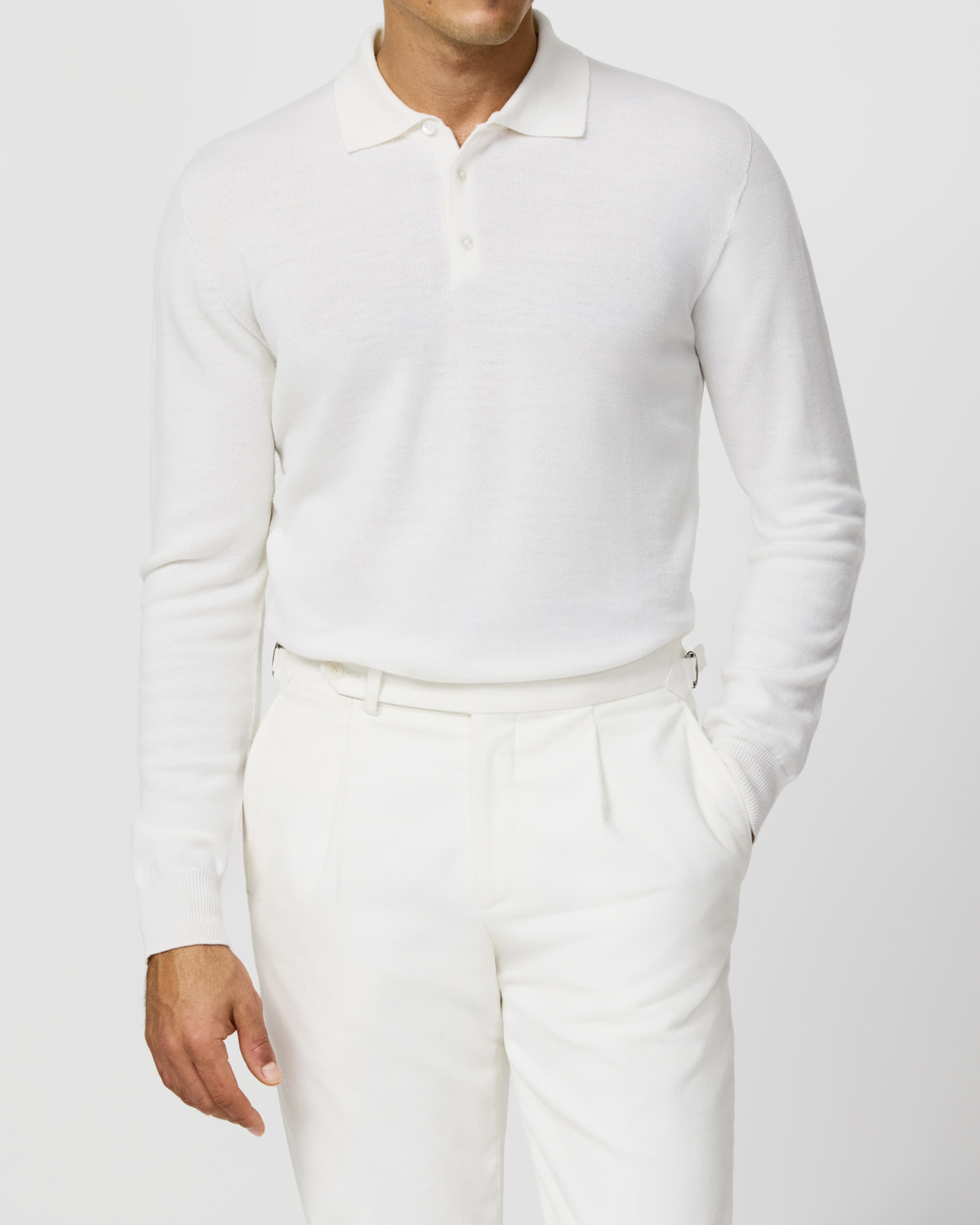 White Consiglieri polo sweater styled with white trousers