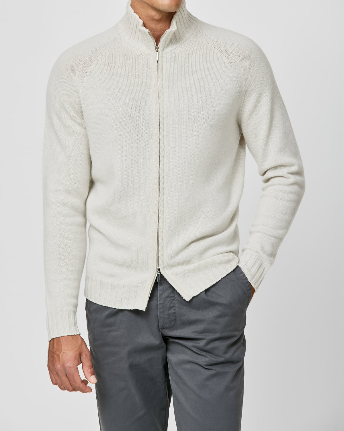 Cream Consiglieri zip cardigan with a stand collar, worn with grey trousers