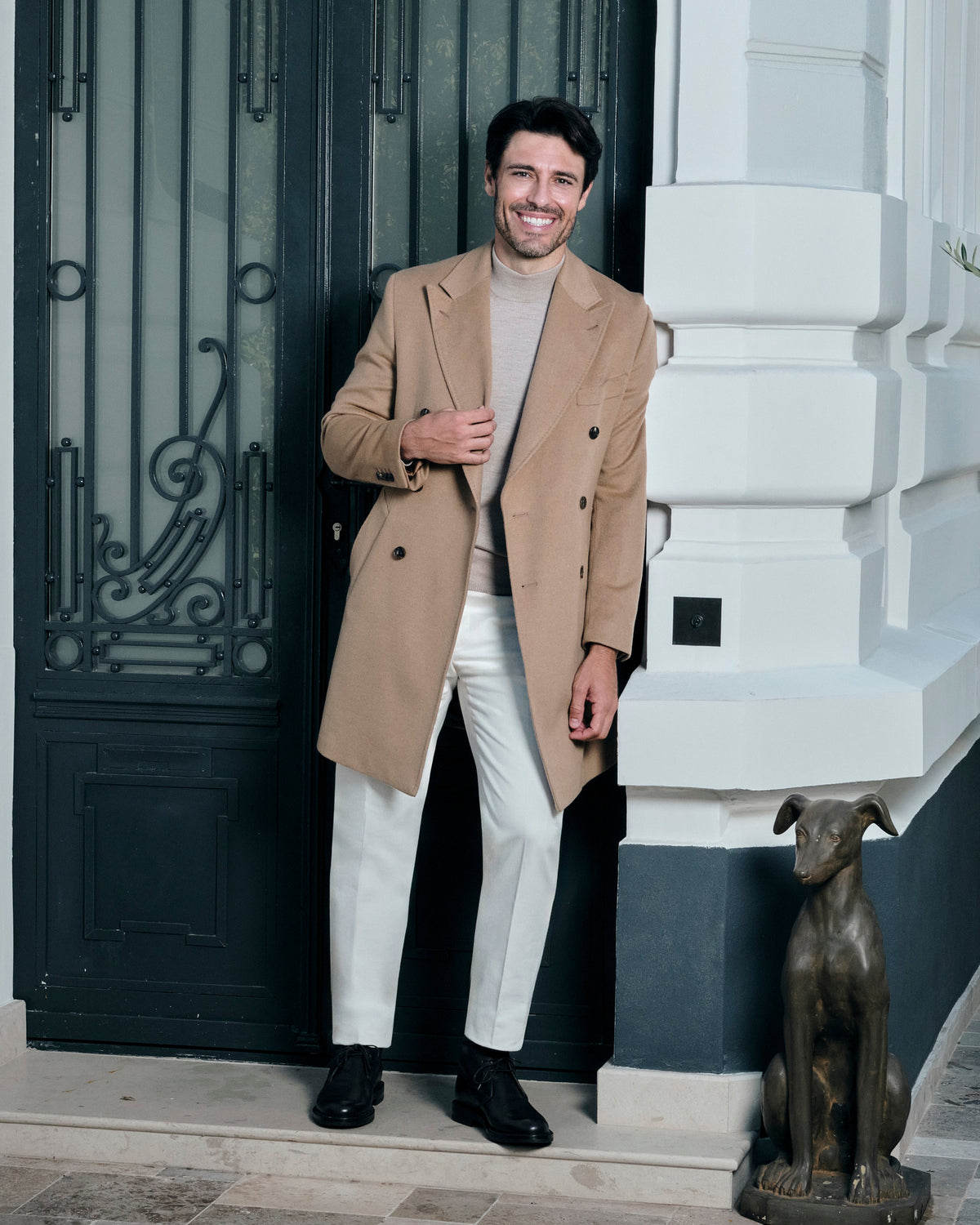 Camel double-breasted Consiglieri overcoat worn with cream trousers