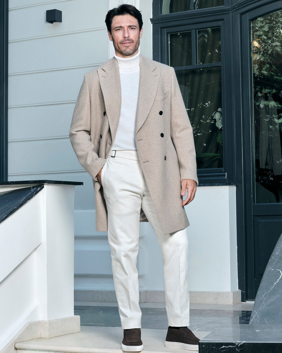 Light beige double-breasted Consiglieri overcoat with a light turtleneck and trousers