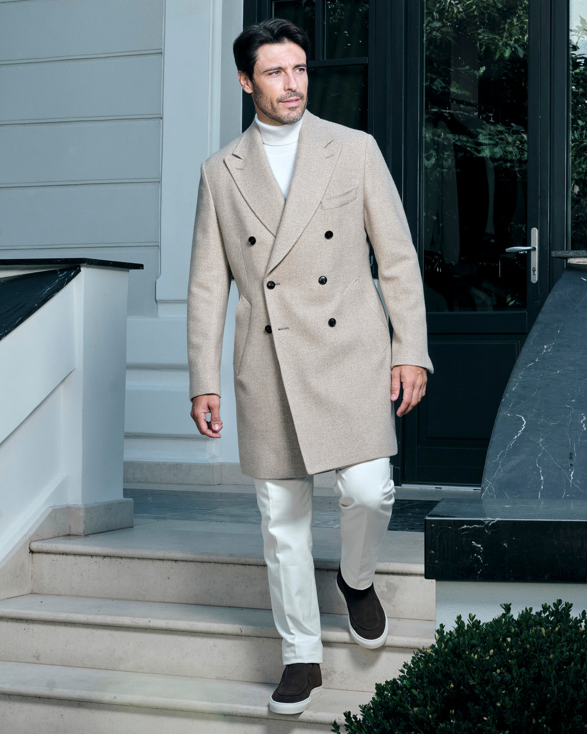 Light beige double-breasted Consiglieri overcoat with a light turtleneck and trousers