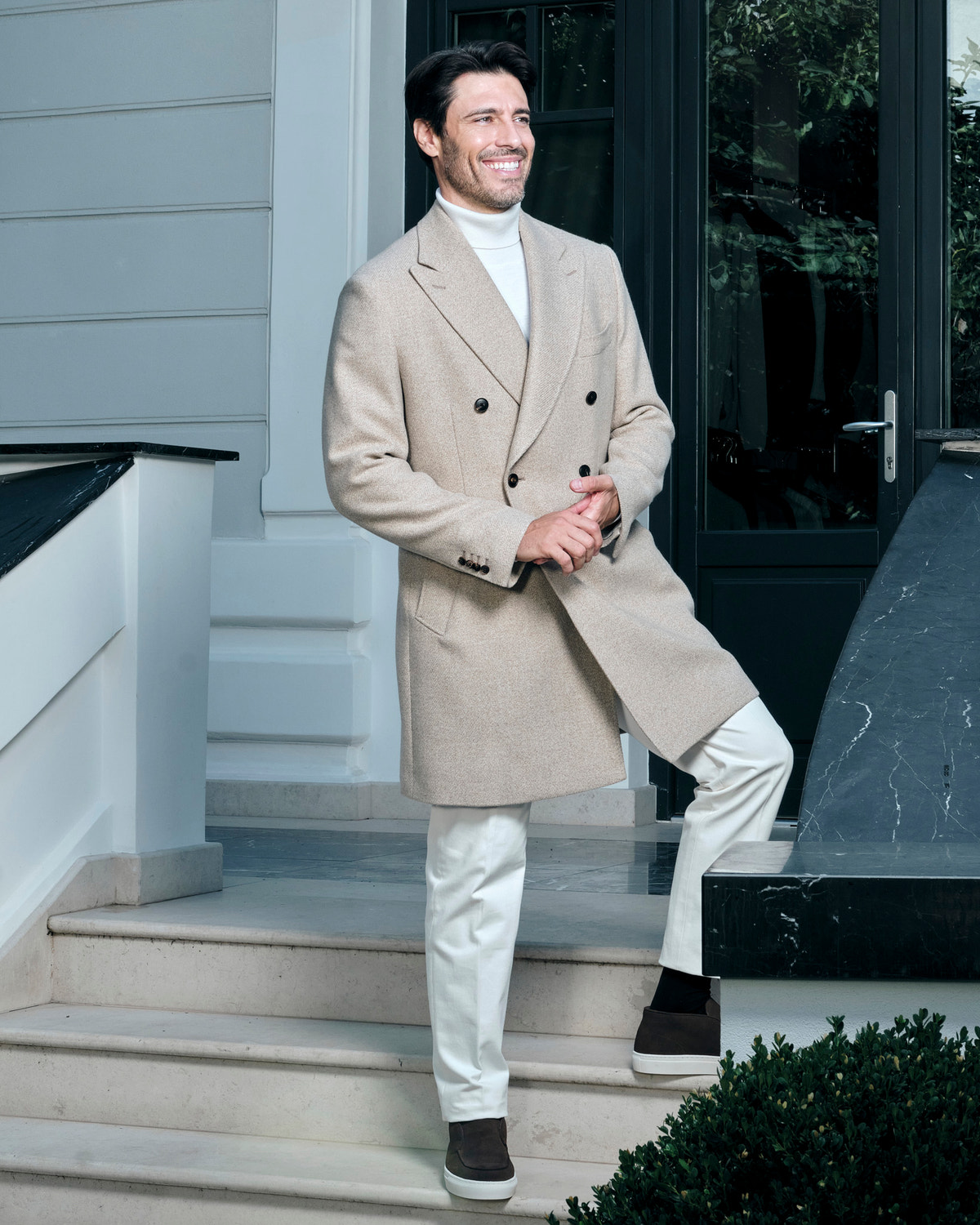 Light beige double-breasted Consiglieri overcoat with a light turtleneck and trousers