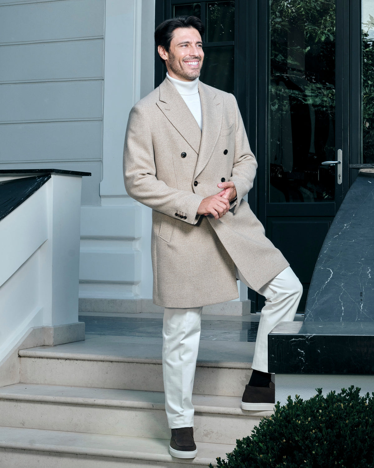 Light beige double-breasted Consiglieri overcoat with a light turtleneck and trousers