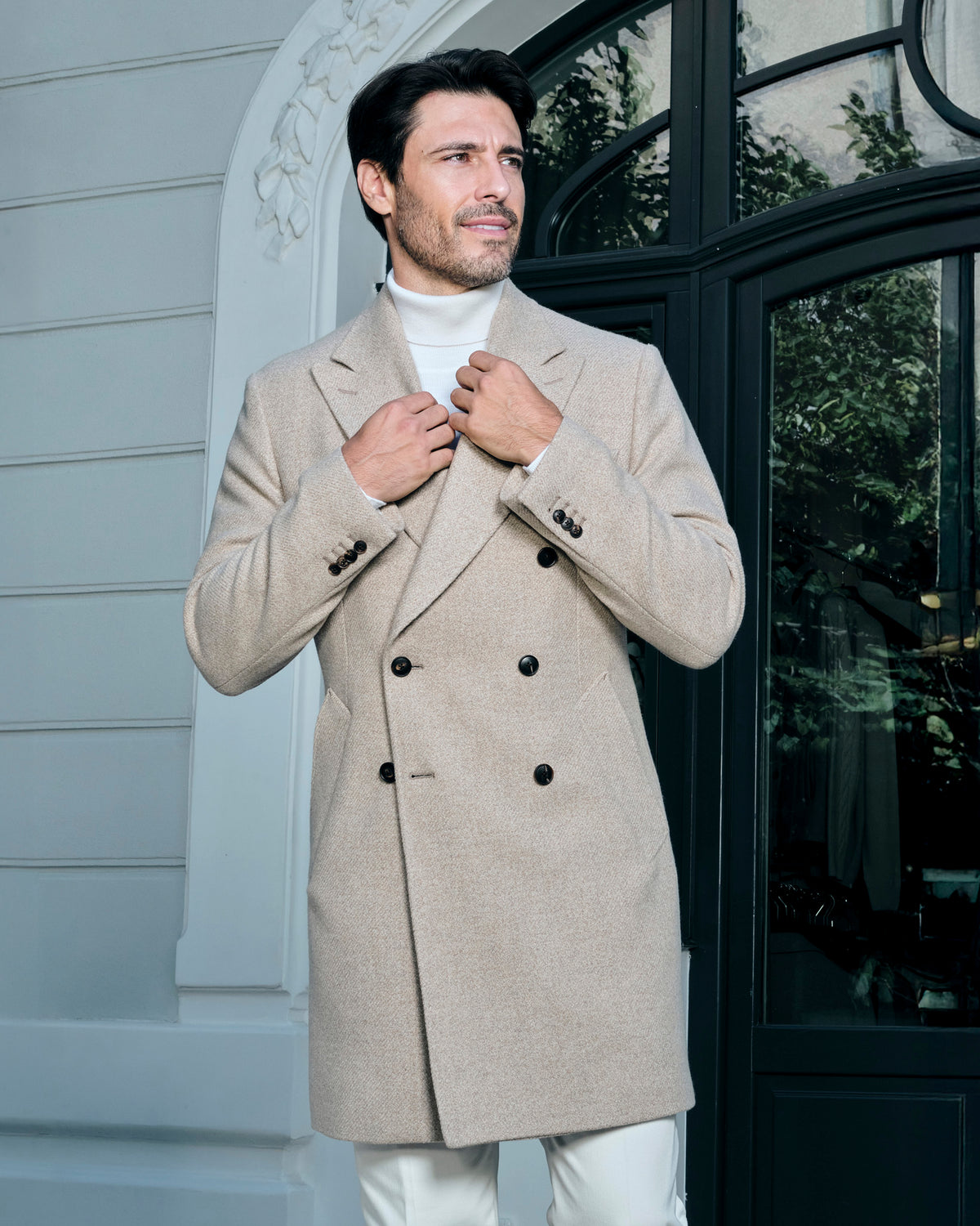 Light beige double-breasted Consiglieri overcoat with a light turtleneck and trousers