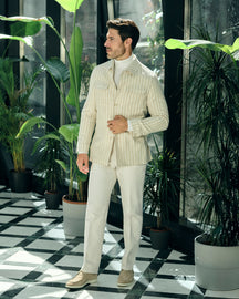 Cream pinstriped Consiglieri jacket with a cream turtleneck and trousers
