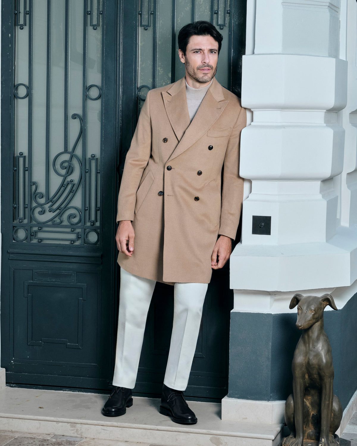 Camel double-breasted Consiglieri overcoat worn with cream trousers