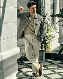 Consiglieri jacket with a small check, worn with a beige turtleneck and cream trousers