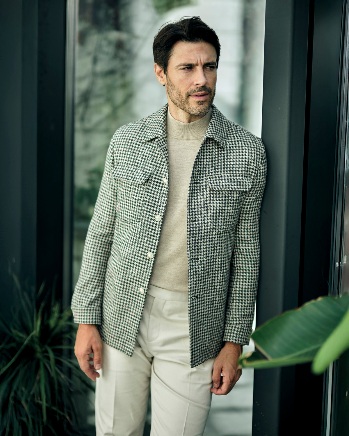 Consiglieri jacket with a small check, worn with a beige turtleneck and cream trousers