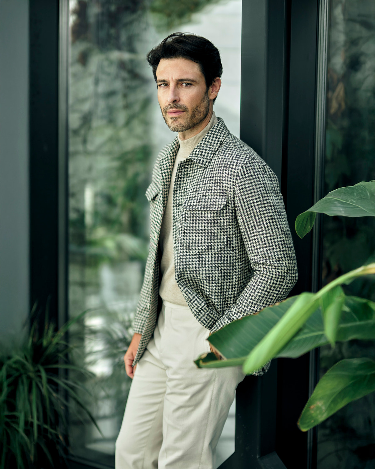 Consiglieri jacket with a small check, worn with a beige turtleneck and cream trousers