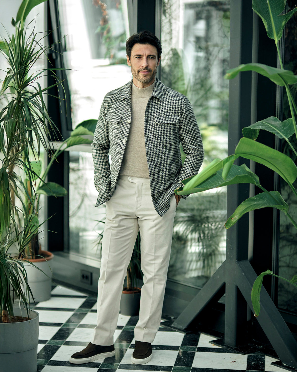 Consiglieri jacket with a small check, worn with a beige turtleneck and cream trousers