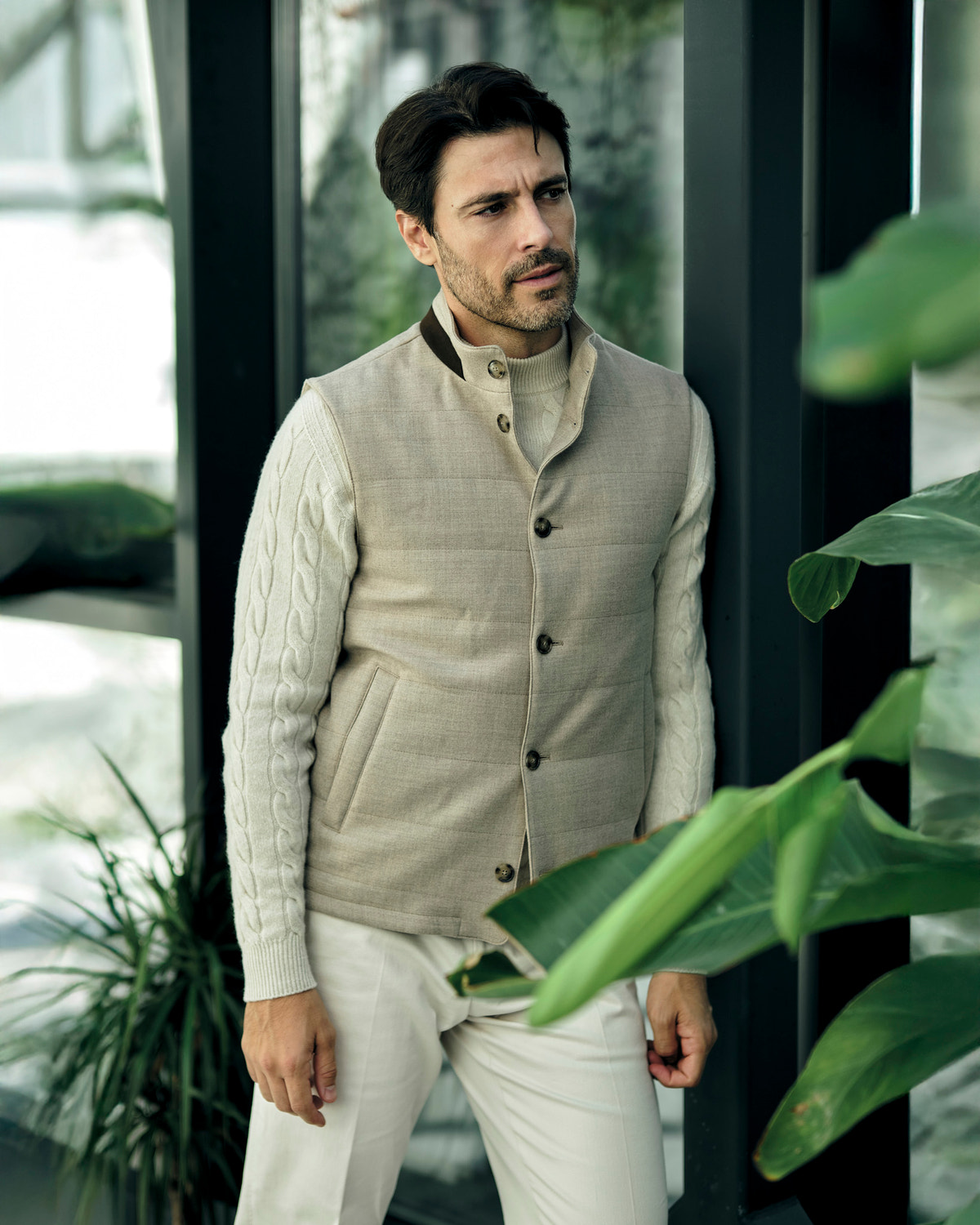Beige quilted Consiglieri gilet with buttons over a cream cable-knit sweater
