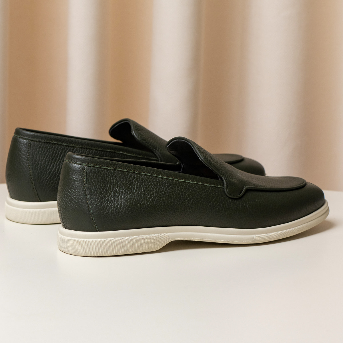 Consiglieri: heel and cream sole of the dark green loafers