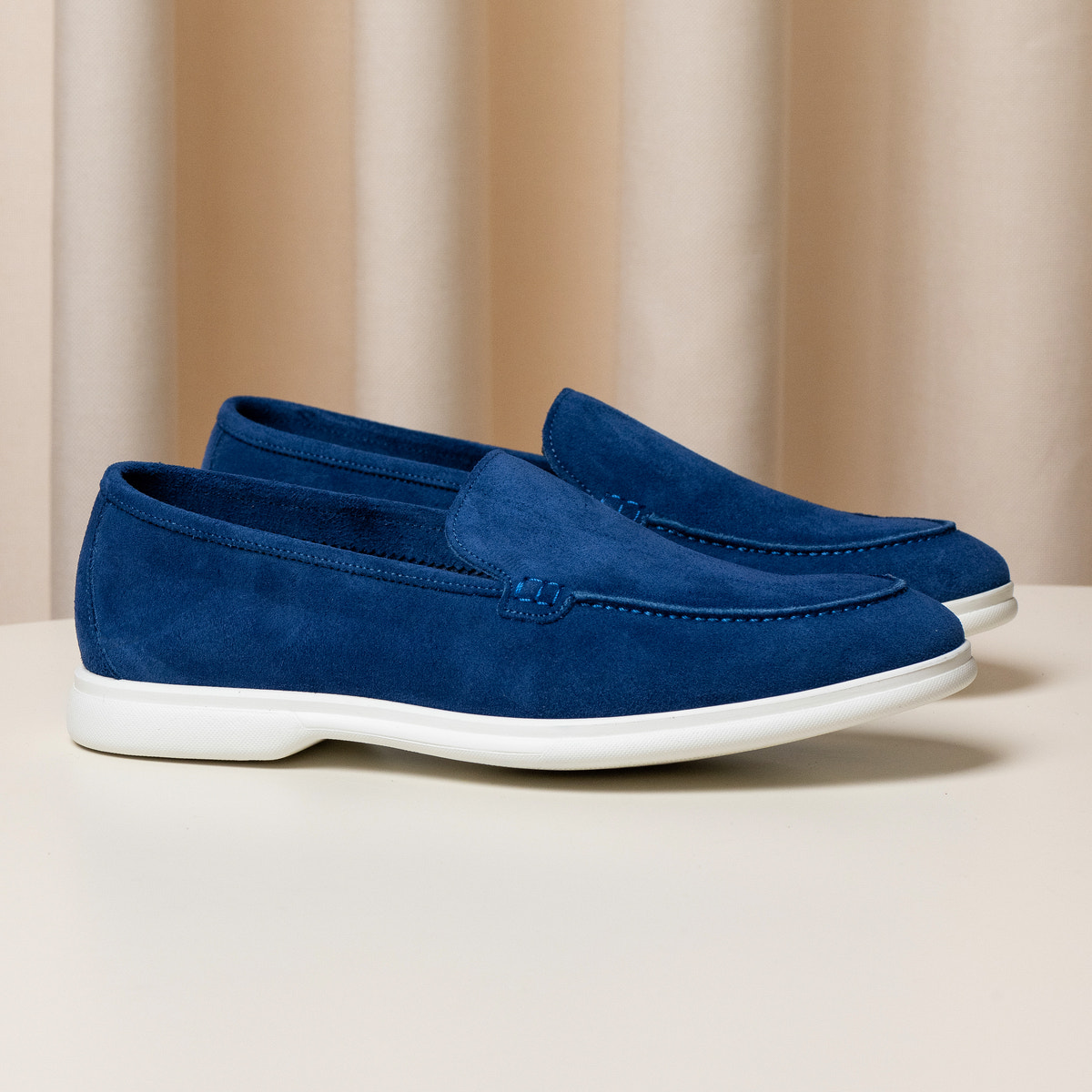 Consiglieri: rich blue loafers with a velvety texture and white soles