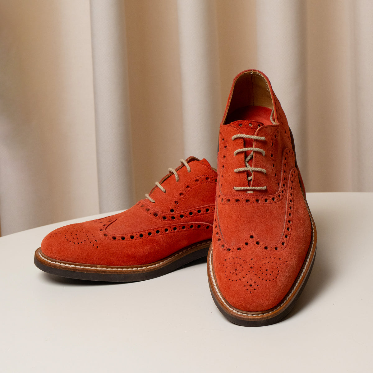 Consiglieri: laces and decorative broguing of the orange Derby shoes