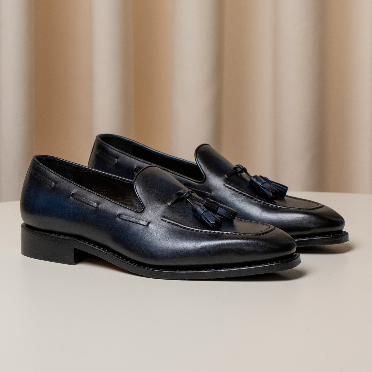 Consiglieri: navy tassel loafers with black soles