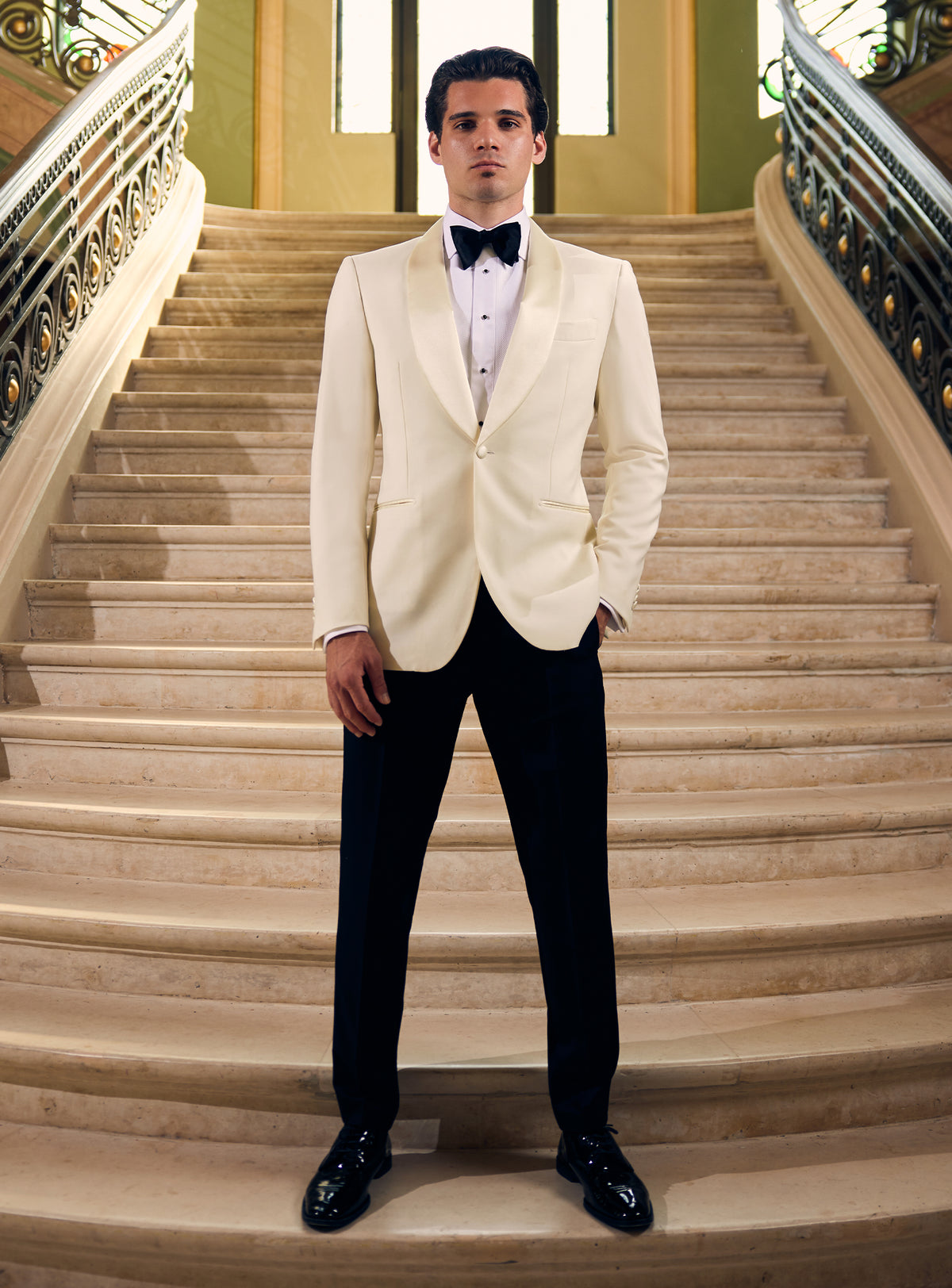 Consiglieri tuxedo with an ivory dinner jacket, black trousers and black bow tie
