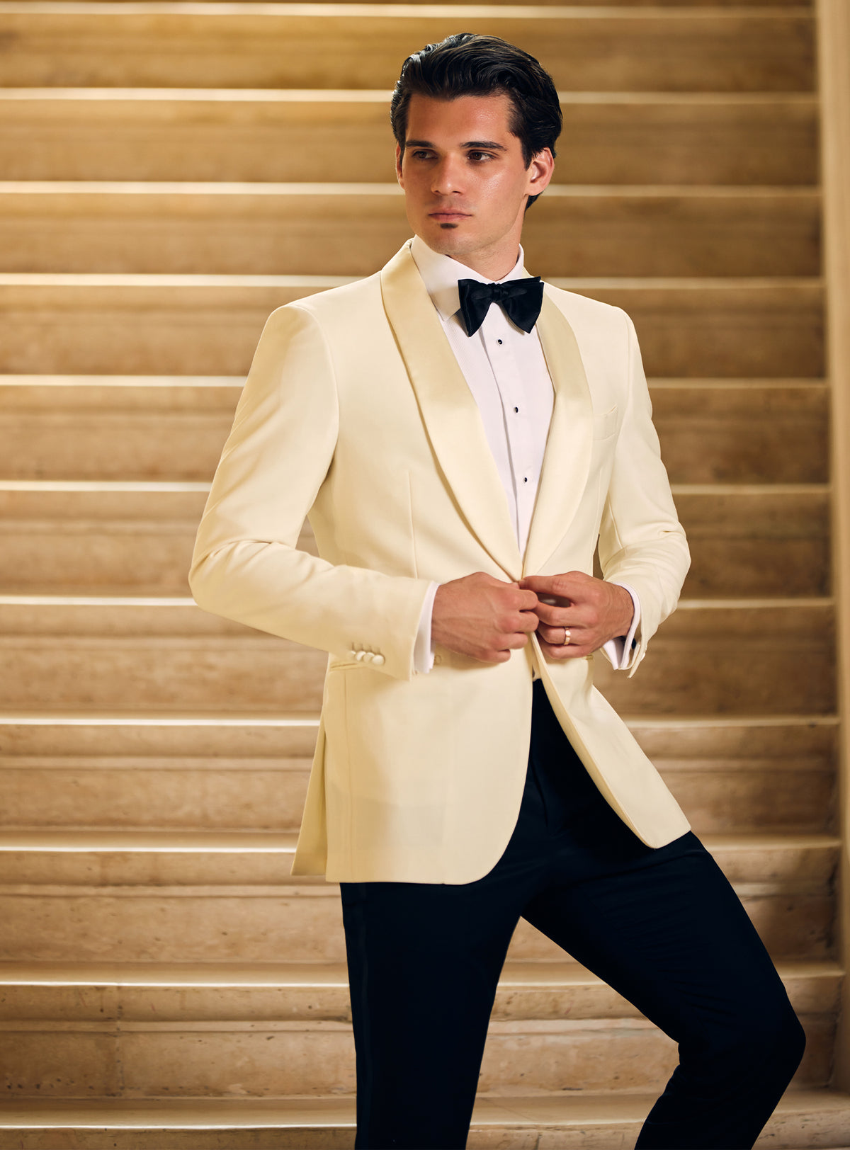 Consiglieri tuxedo with an ivory dinner jacket, black trousers and black bow tie