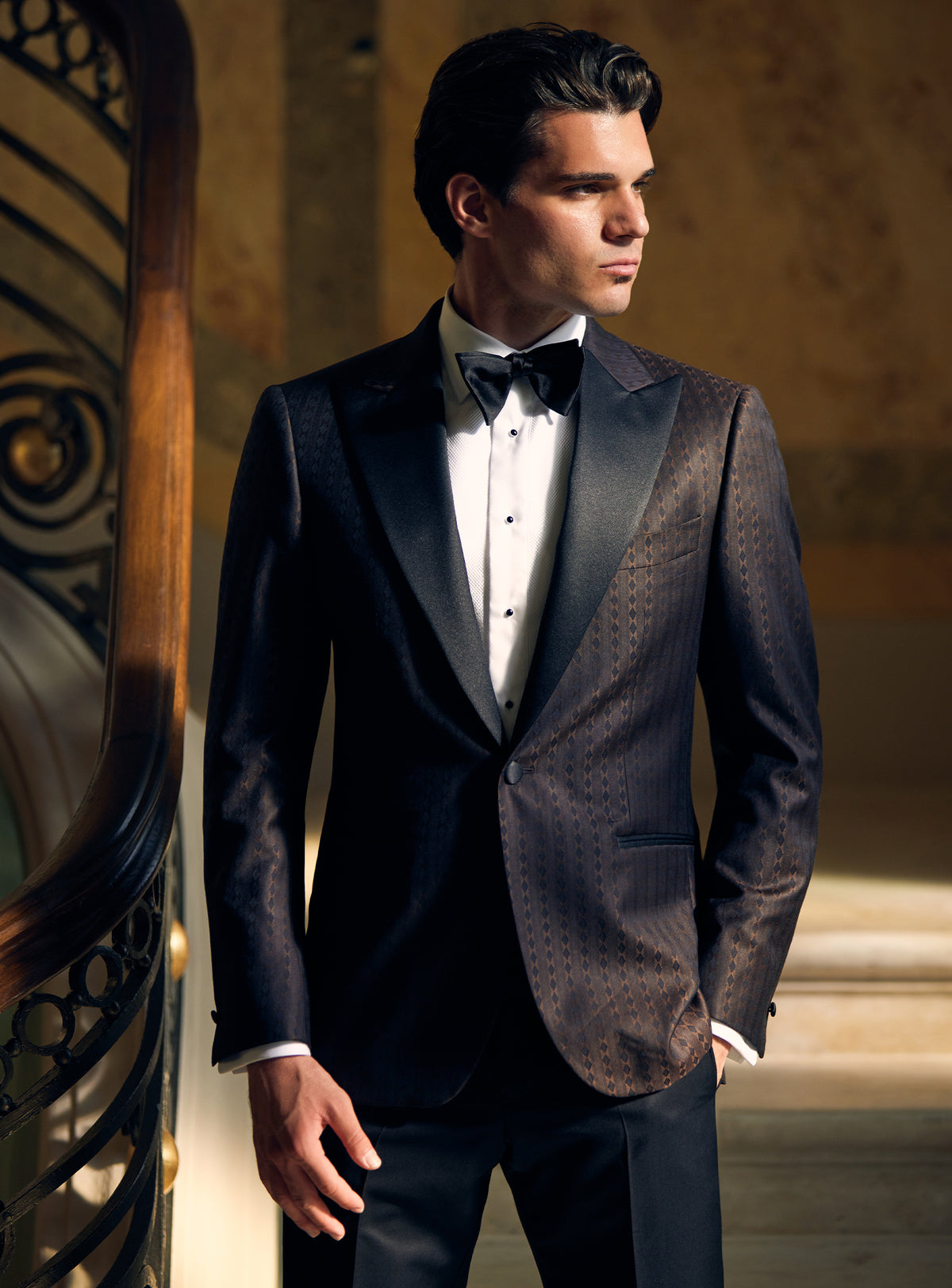 Dark Consiglieri tuxedo with a textured dinner jacket, lustrous lapels and black bow tie