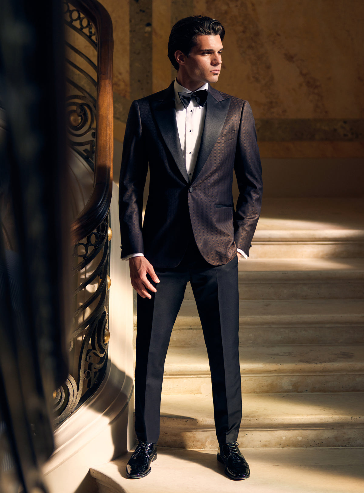 Dark Consiglieri tuxedo with a textured dinner jacket, lustrous lapels and black bow tie