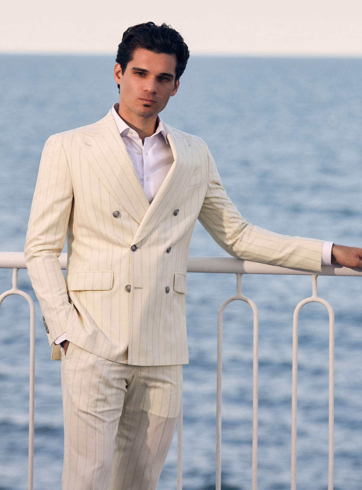 Cream pinstriped double-breasted Consiglieri suit worn with a white shirt