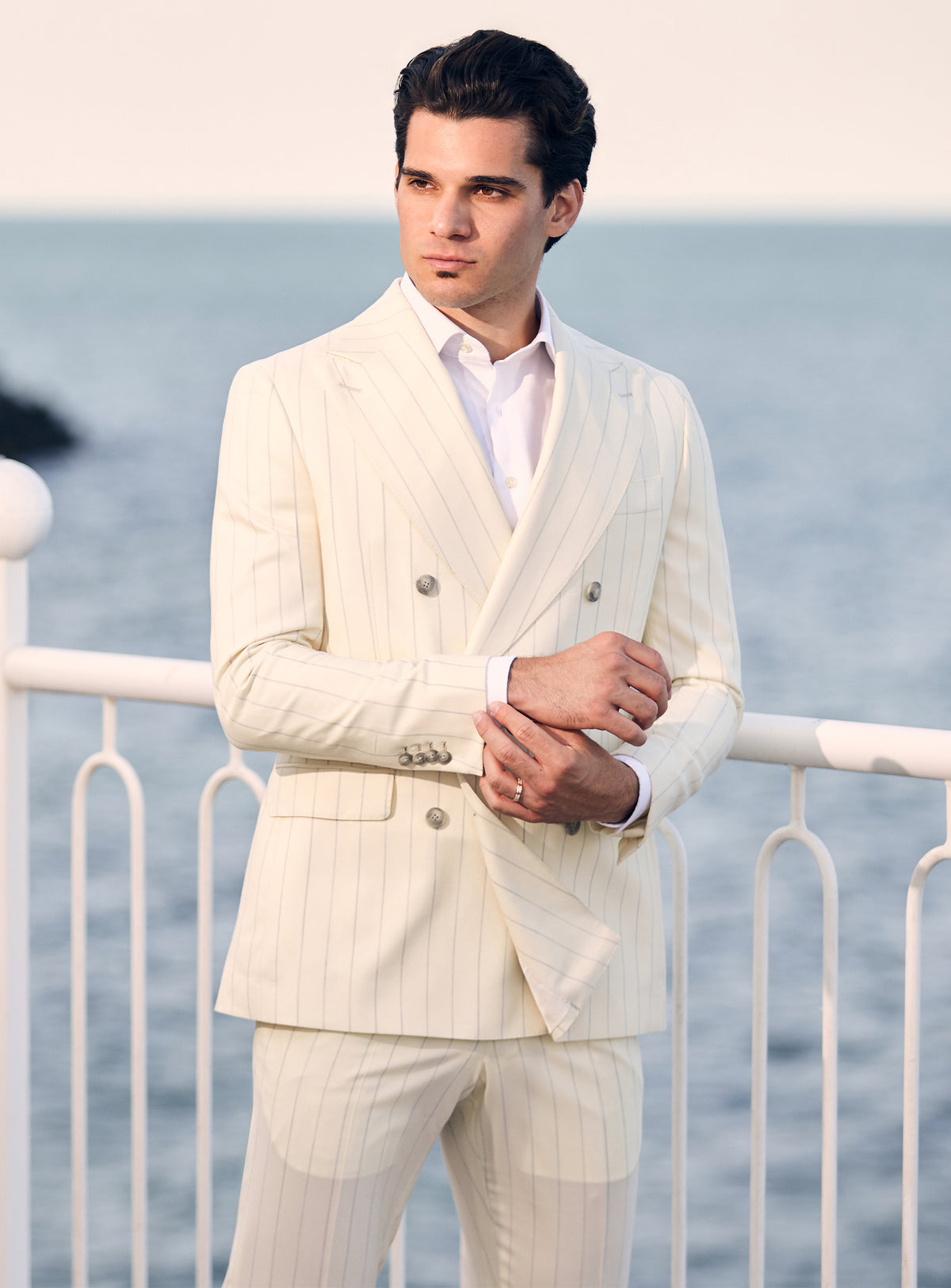 Cream pinstriped double-breasted Consiglieri suit worn with a white shirt