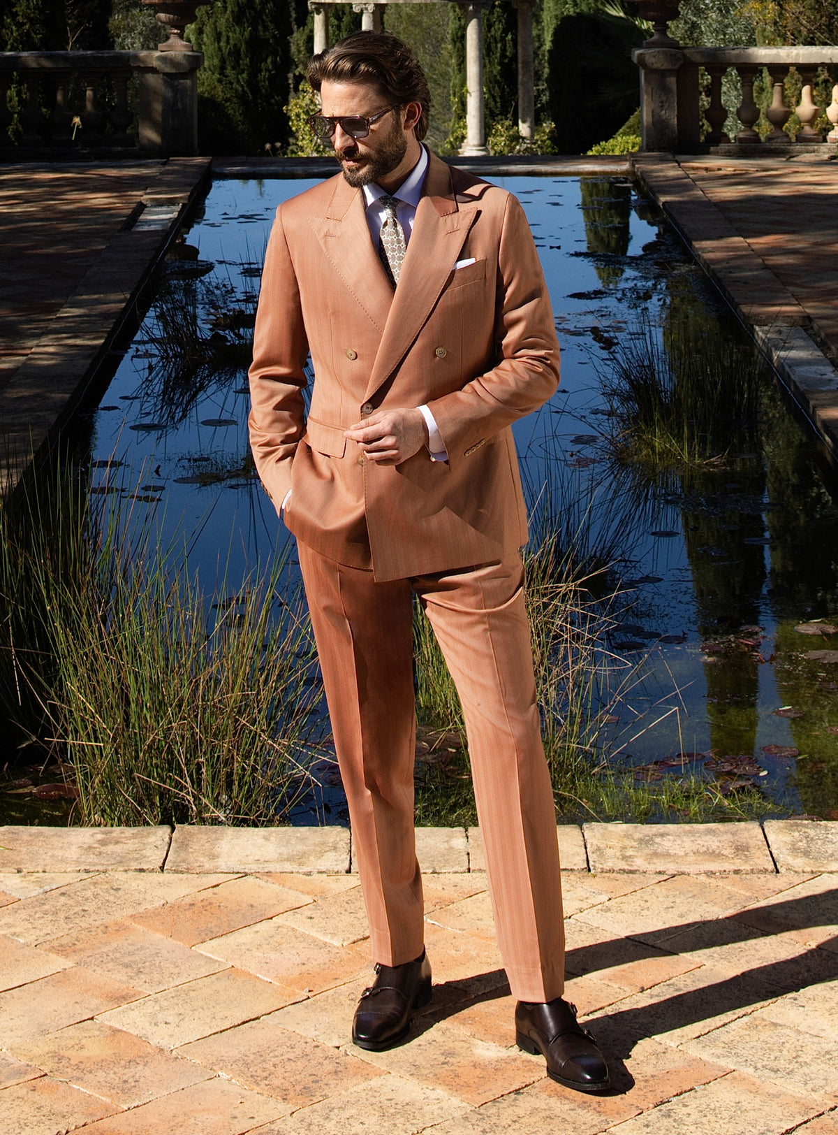 Terracotta double-breasted Consiglieri suit worn with a white shirt