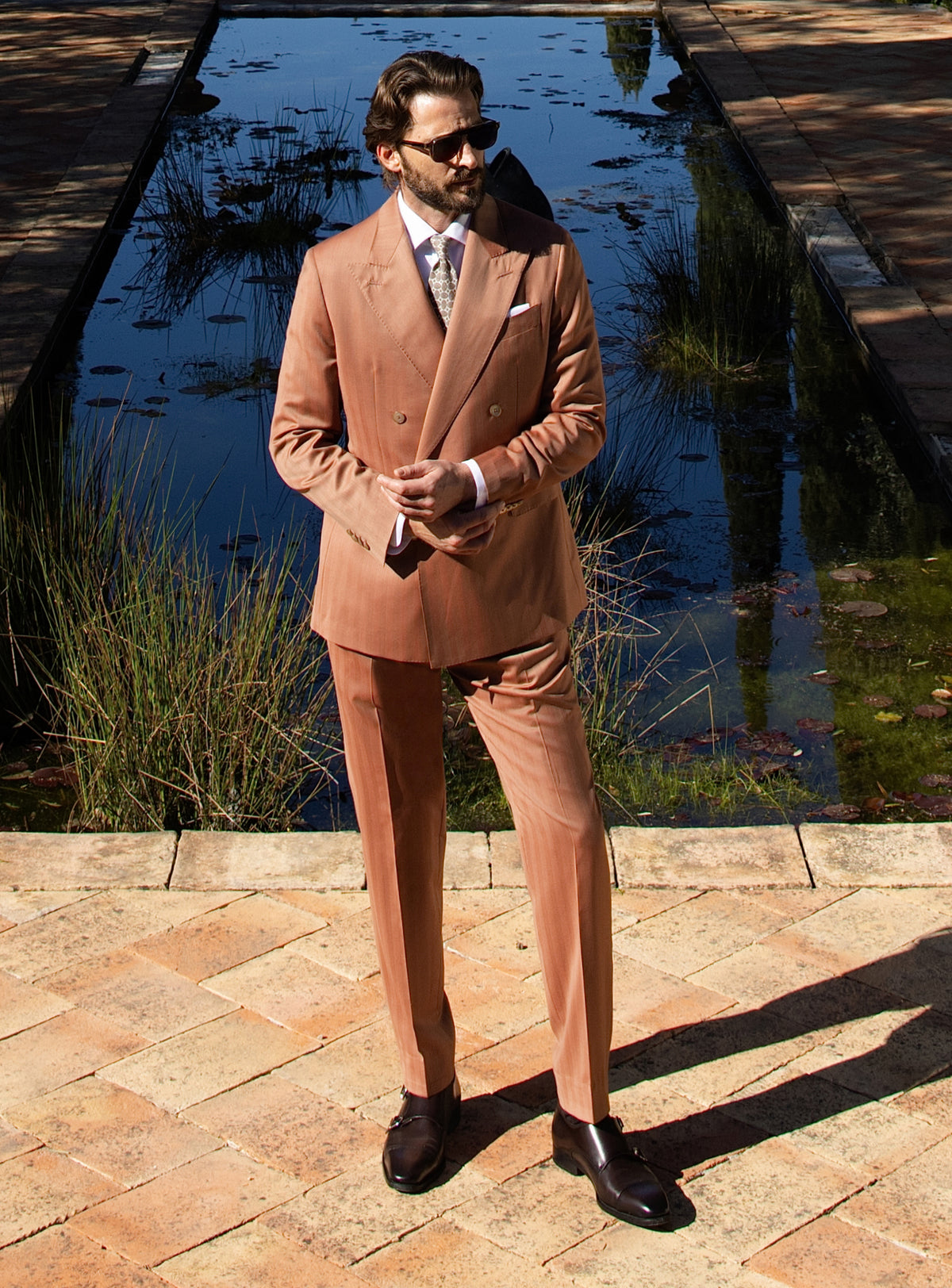 Terracotta double-breasted Consiglieri suit worn with a white shirt