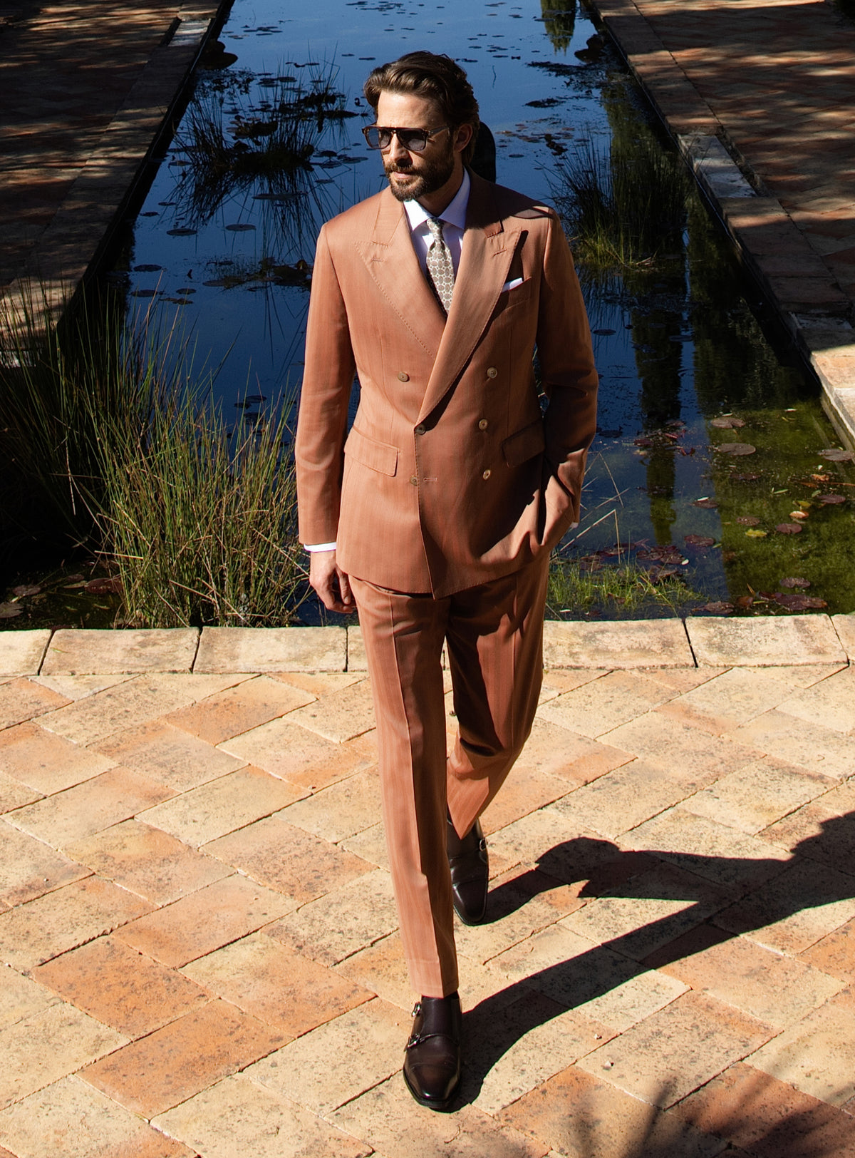 Terracotta double-breasted Consiglieri suit worn with a white shirt