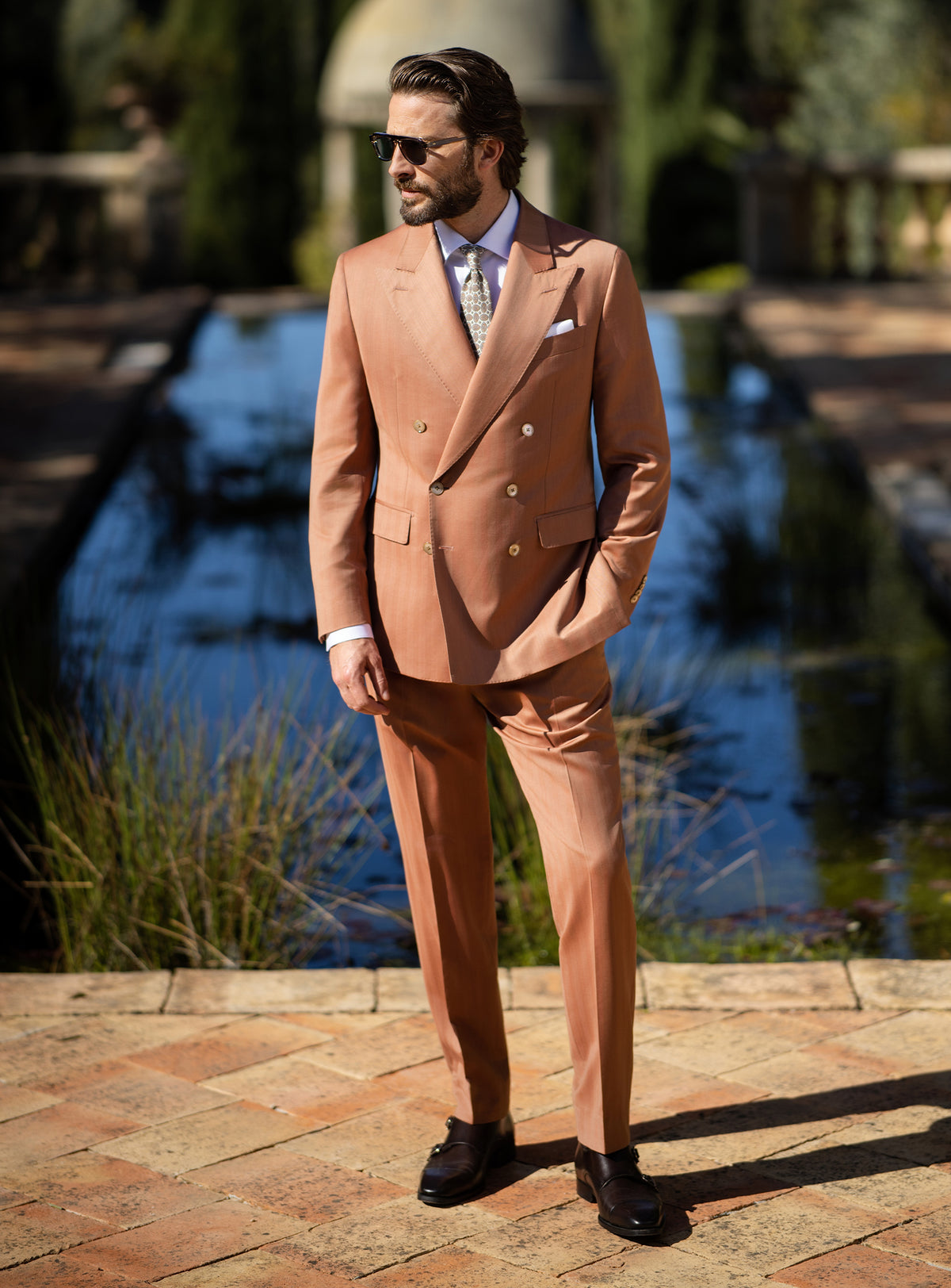Terracotta double-breasted Consiglieri suit worn with a white shirt
