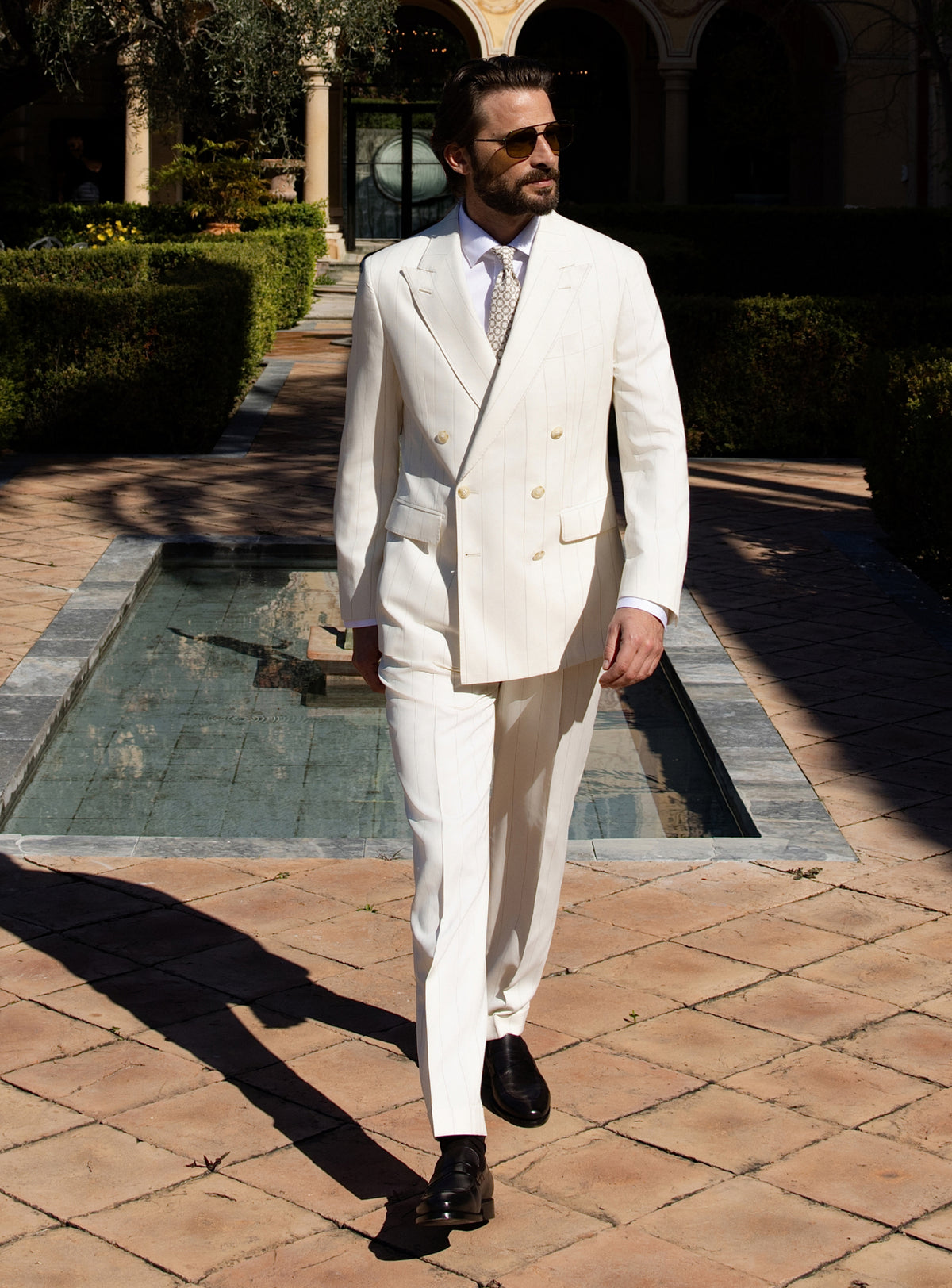 Ivory double-breasted Consiglieri suit worn with a white shirt