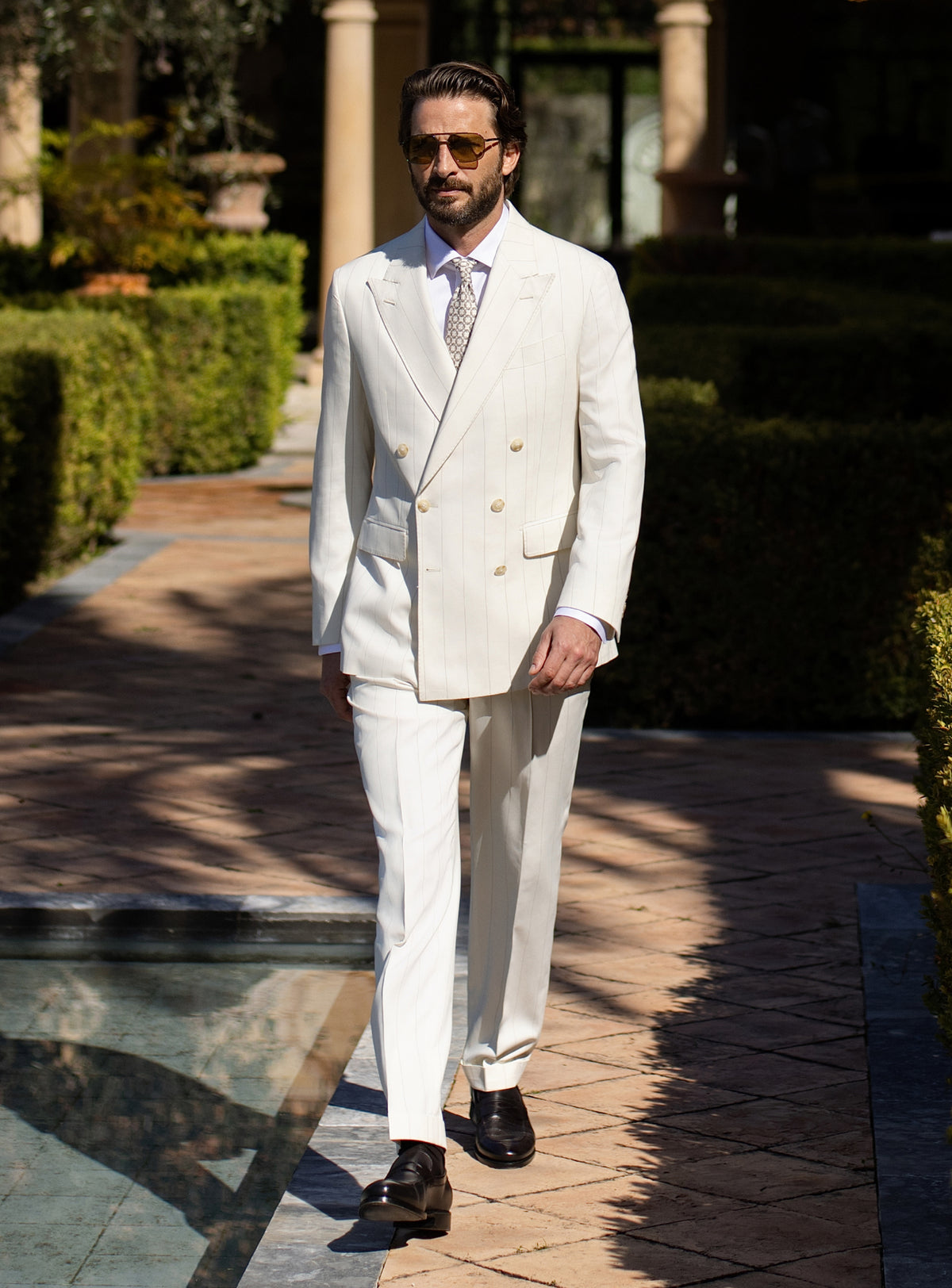 Ivory double-breasted Consiglieri suit worn with a white shirt