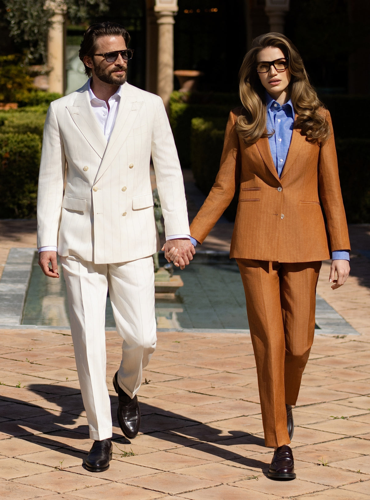 Ivory men's suit and camel women's suit by Consiglieri, styled as a couple