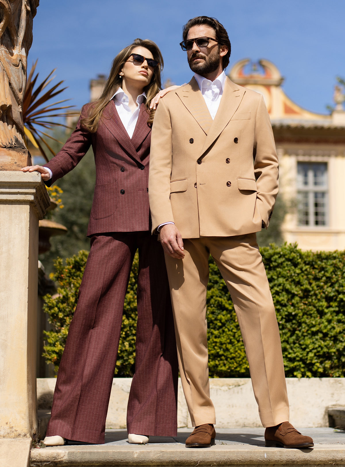Camel men's suit and burgundy women's suit by Consiglieri, styled as a couple