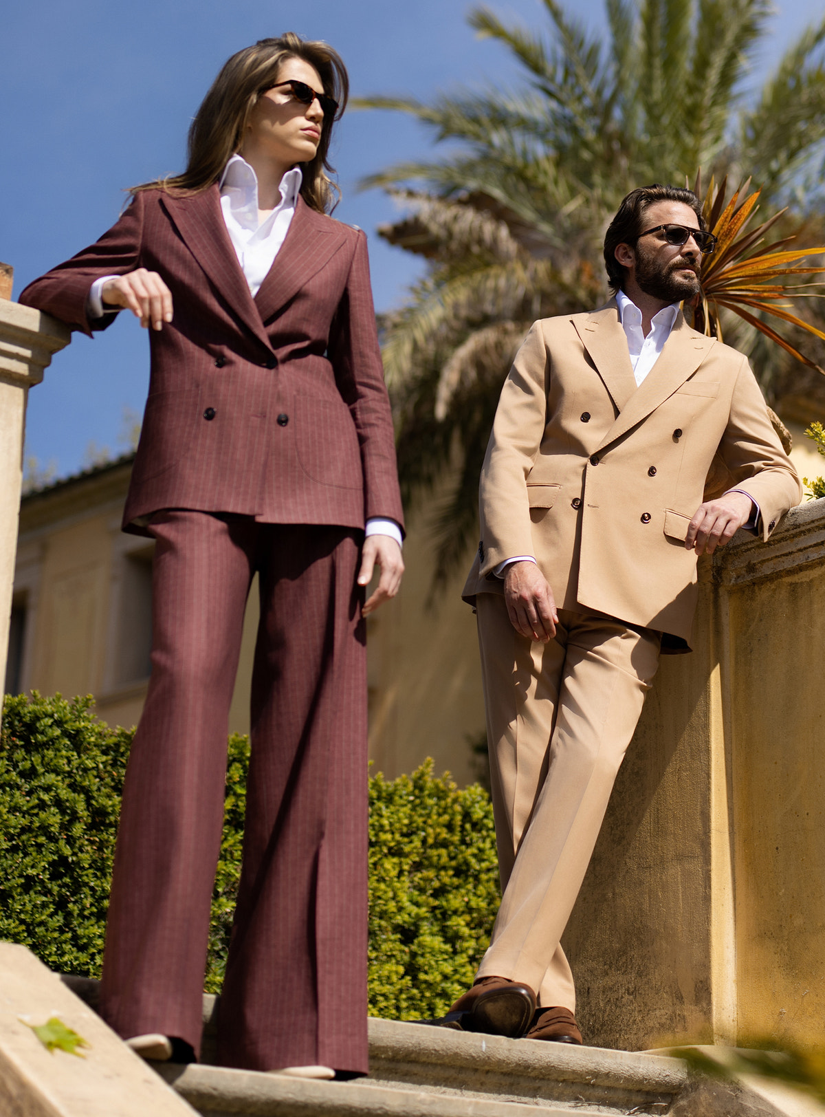 Camel men's suit and burgundy women's suit by Consiglieri, styled as a couple