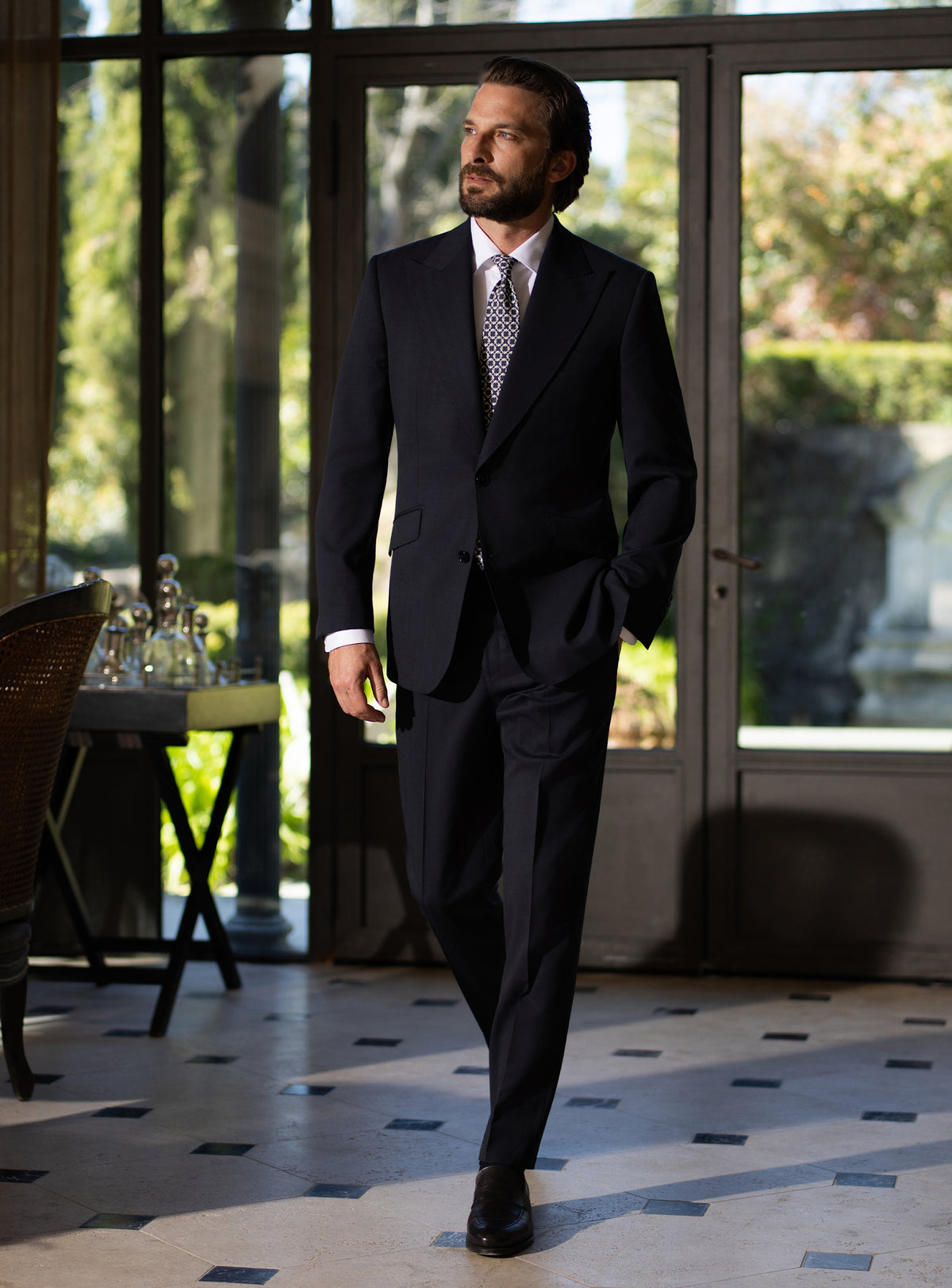 Deep navy Consiglieri suit worn with a white shirt and patterned tie
