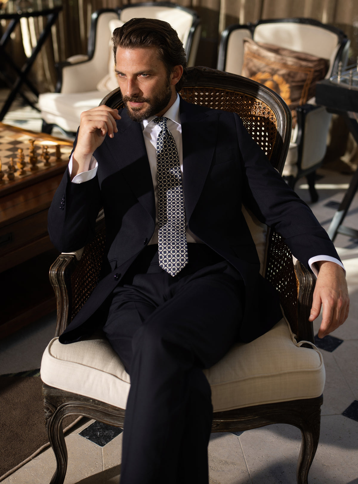 Deep navy Consiglieri suit worn with a white shirt and patterned tie