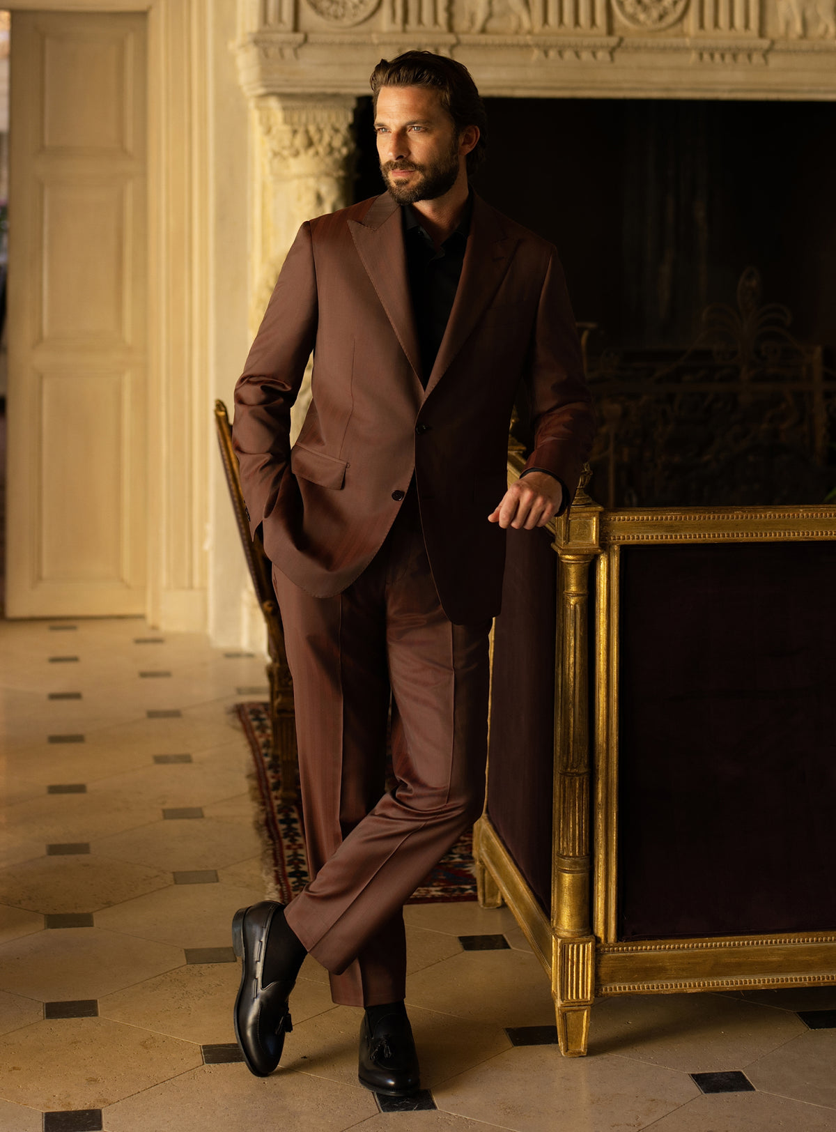 Brown Consiglieri suit worn with a black turtleneck and black loafers