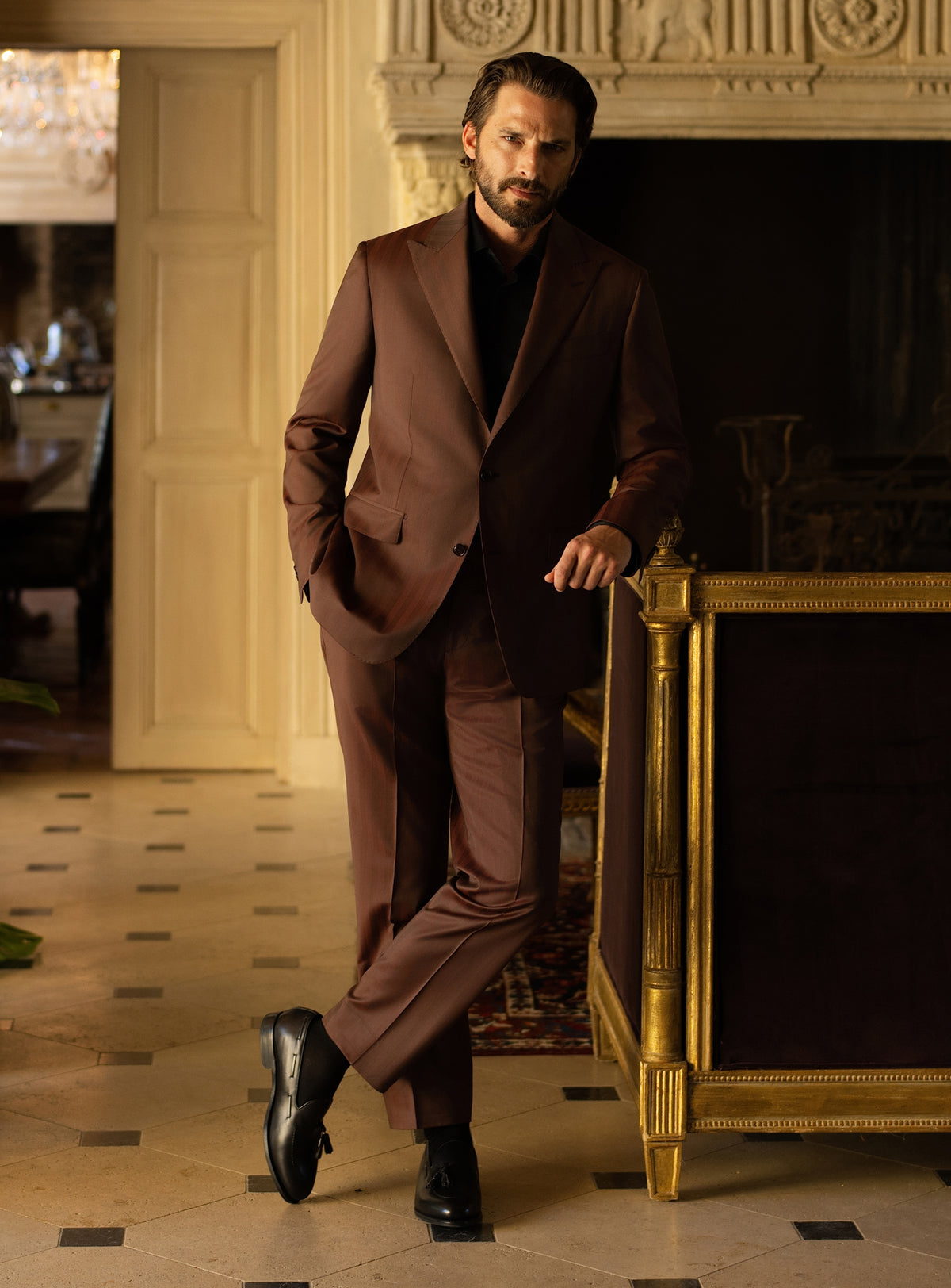 Brown Consiglieri suit worn with a black turtleneck and black loafers