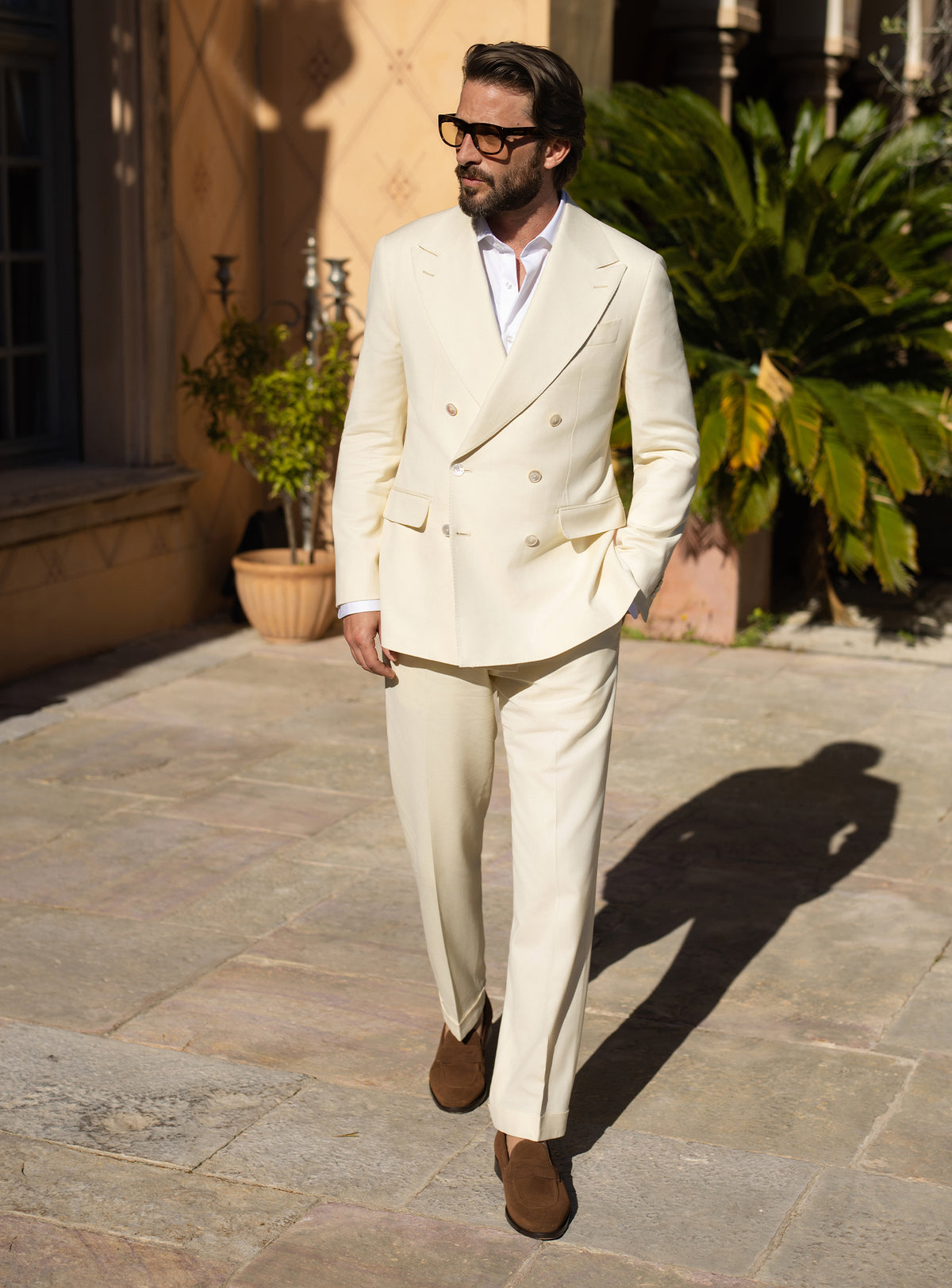 Cream double-breasted Consiglieri suit worn with a white shirt
