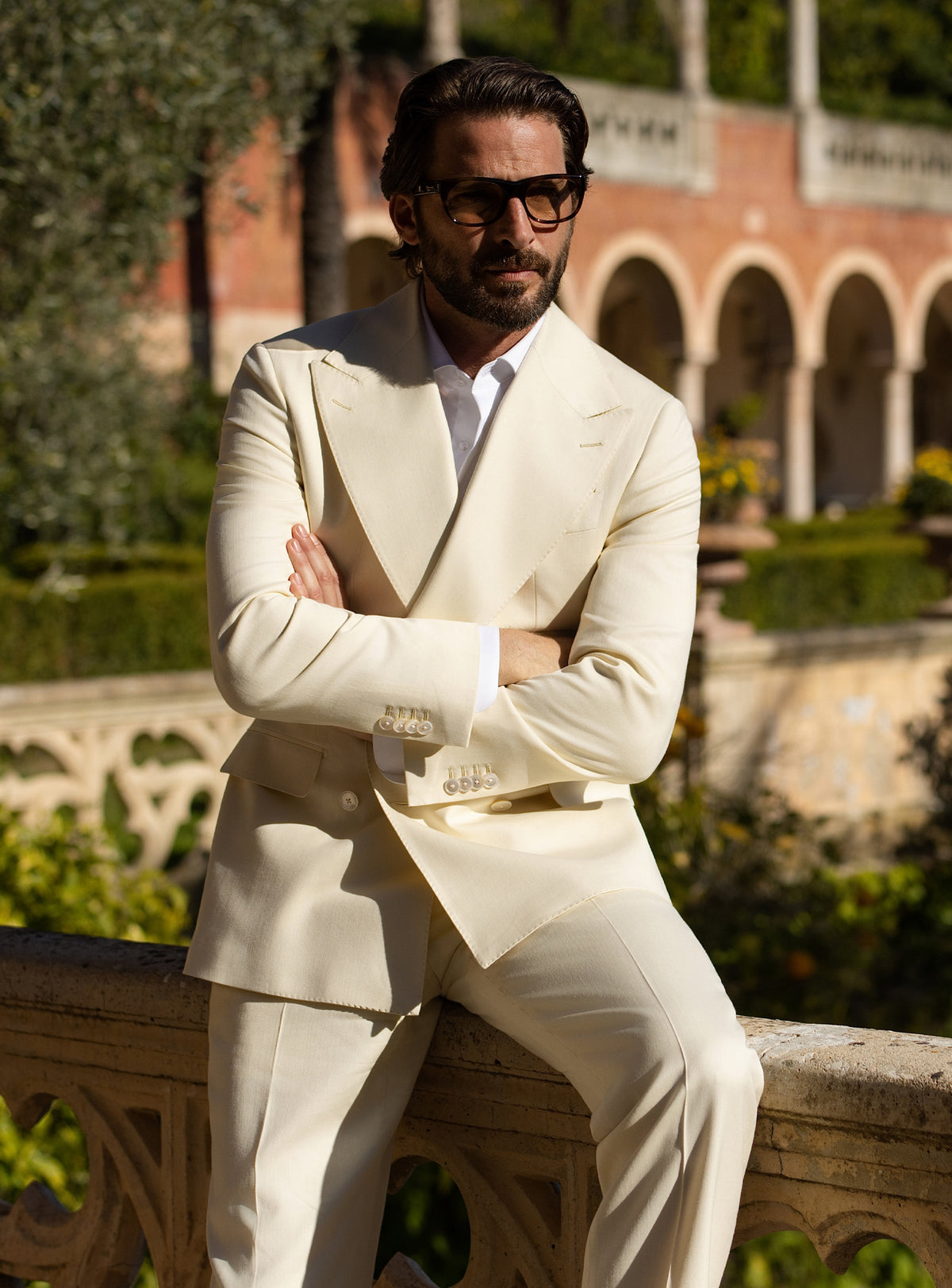 Cream double-breasted Consiglieri suit worn with a white shirt