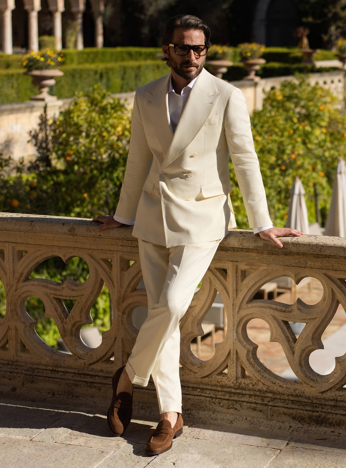 Cream double-breasted Consiglieri suit worn with a white shirt