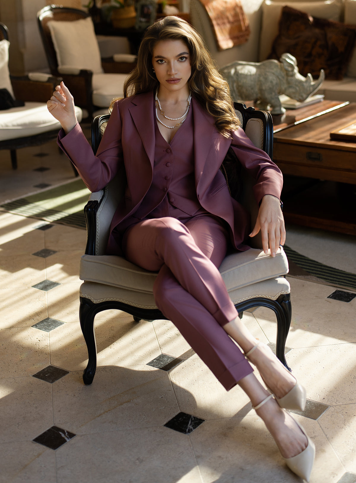 Women's purple suit worn while seated in a bright interior