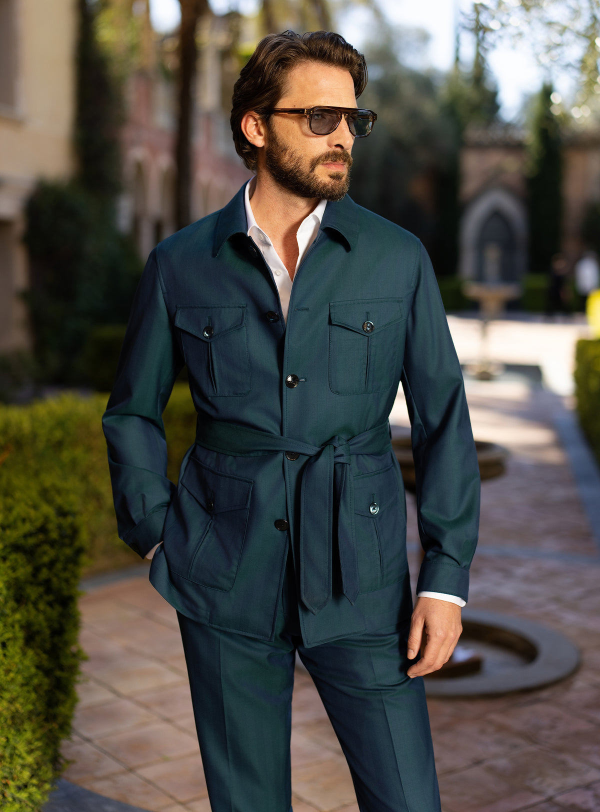 Teal Consiglieri ensemble with a belted patch-pocket jacket and matching trousers
