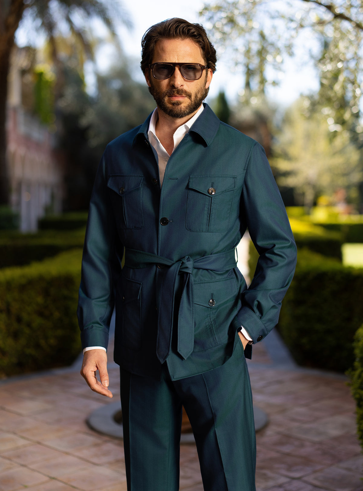 Teal Consiglieri ensemble with a belted patch-pocket jacket and matching trousers
