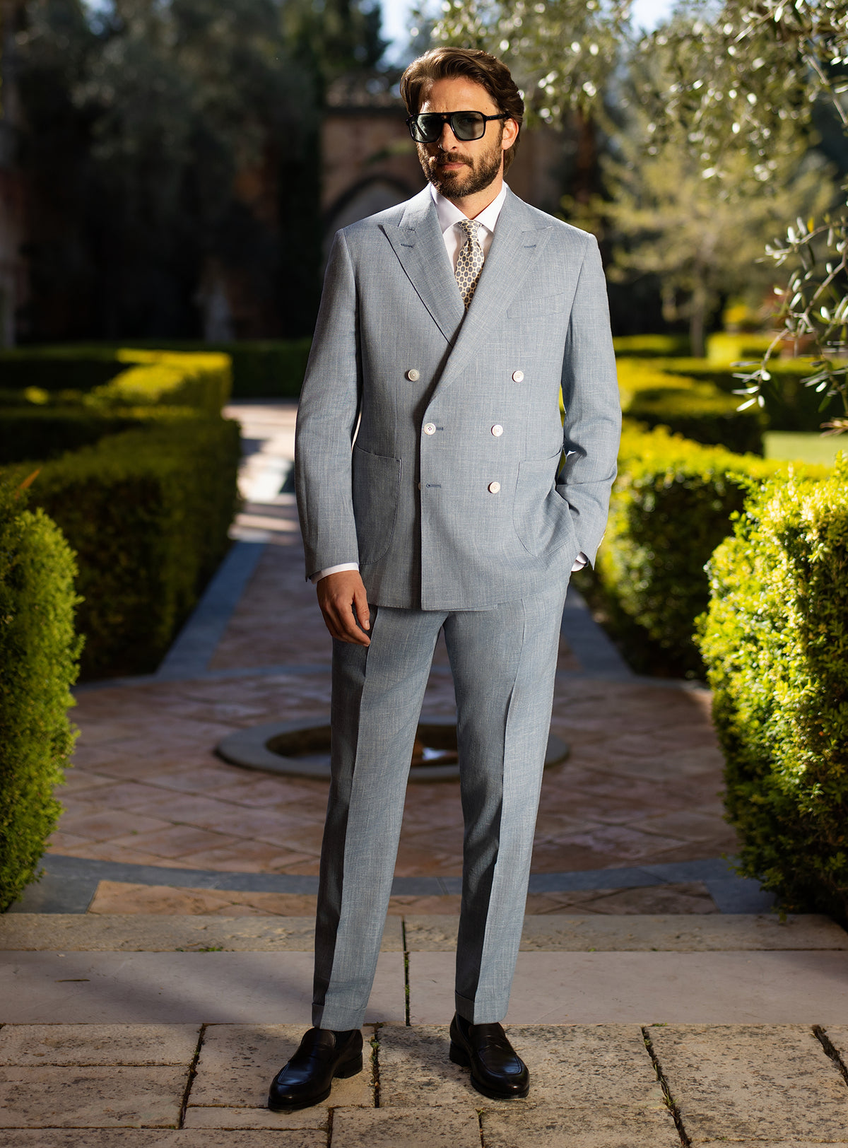 Light blue-grey double-breasted Consiglieri suit worn with a patterned tie